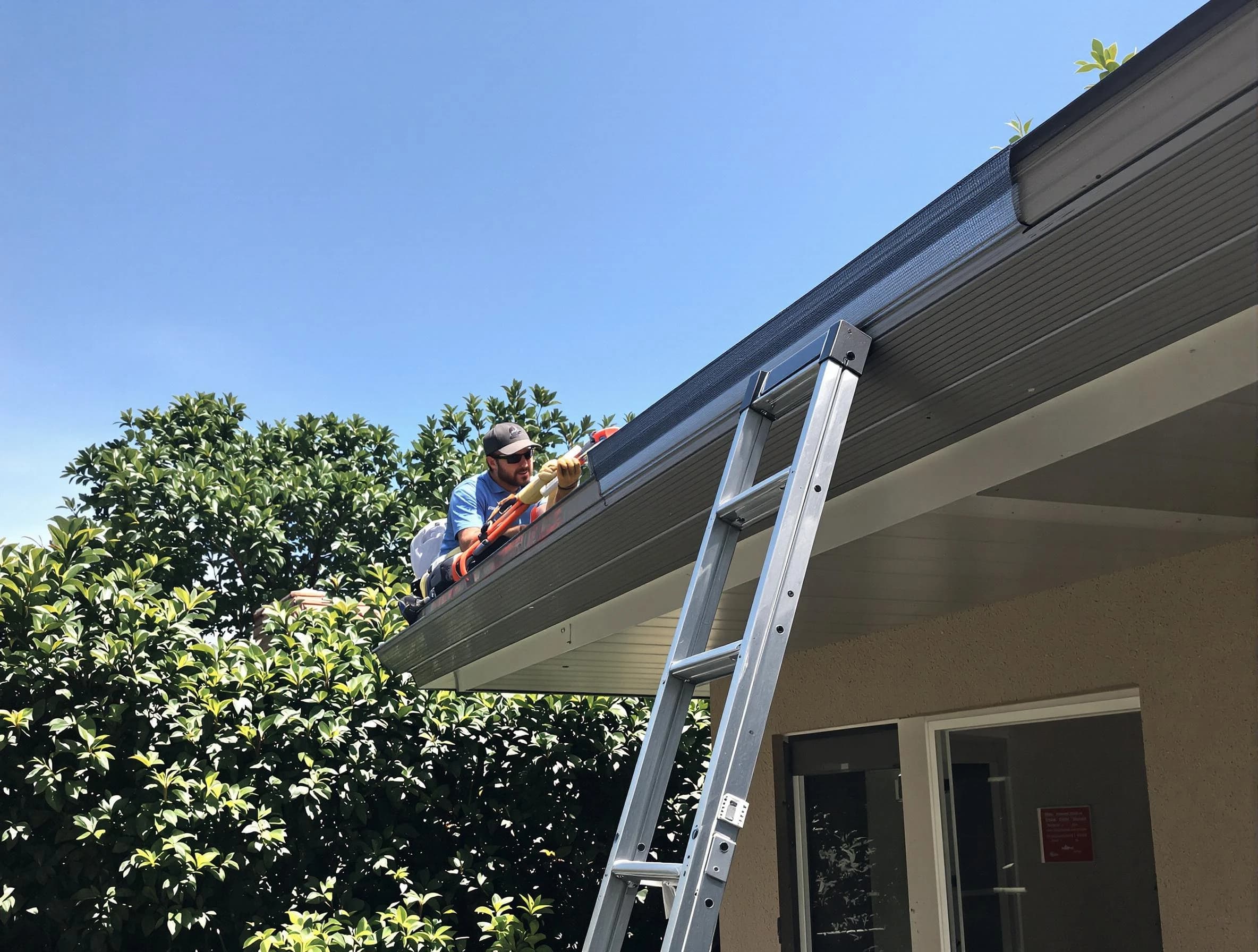 Akron Roofing Company installing gutter guards for a homeowner in Akron, OH